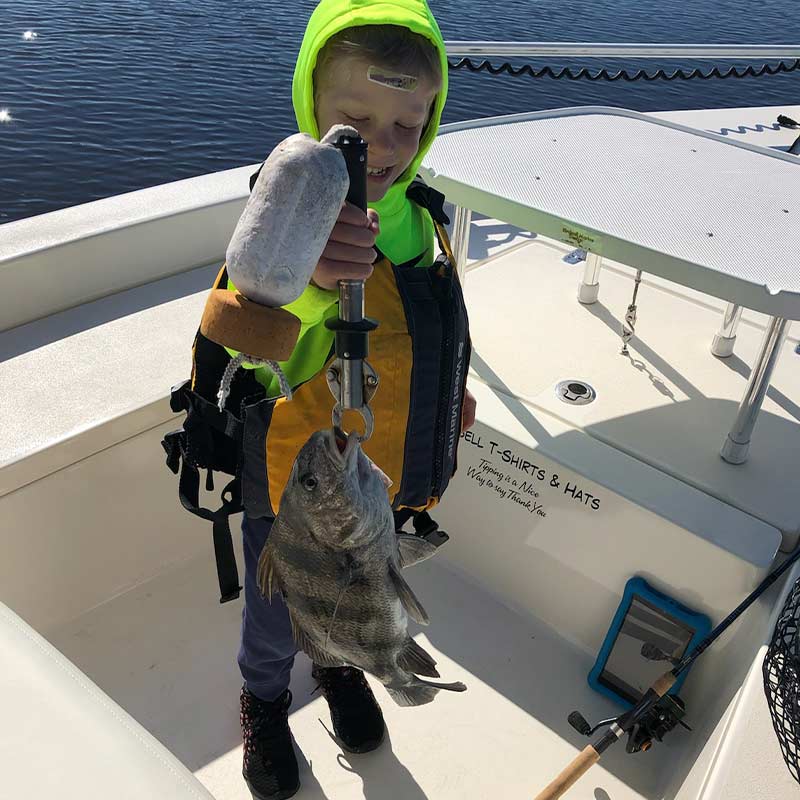 A young angler with a cold-weather black drum