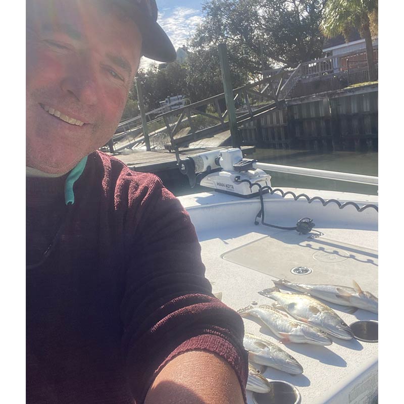 Captain Tom in front of some nice trout caught on his boat