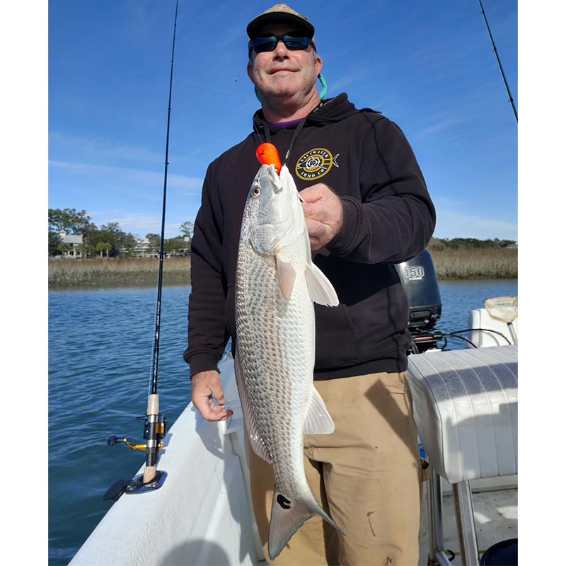 Captain Tom Cushman with a 24-inch redfish caught yesterday