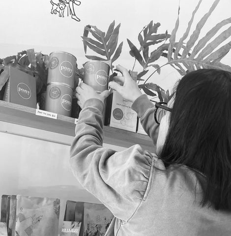 lady stocking shelves with coffee