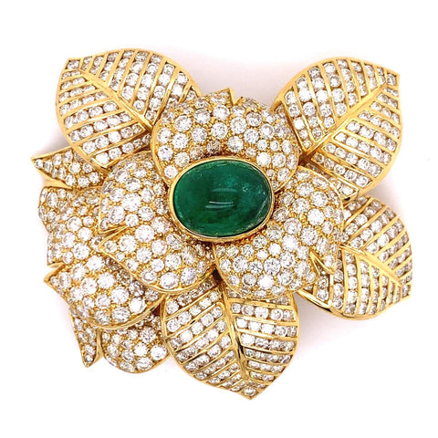 Gold flower brooch features diamonds weighing approximately 30-carats, and cabochon emerald weighing approximately 10-carats