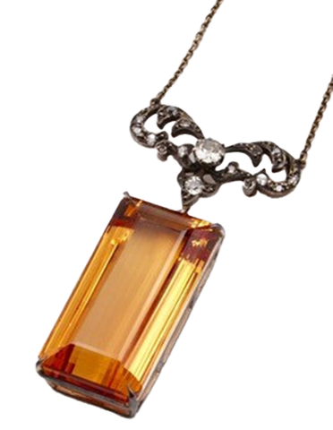 Rare antique silver on gold pendant showcases a 106.82-carat imperial topaz with diamond accents.