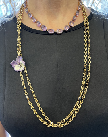 Victorian enamel pansy brooch, signed Cartier, is attached to a gold long chain worn with an amethyst choker