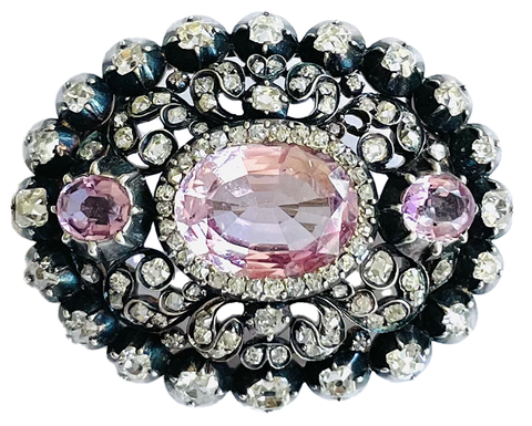 Victorian silver on gold brooch features three pink topaz with old mine diamonds.