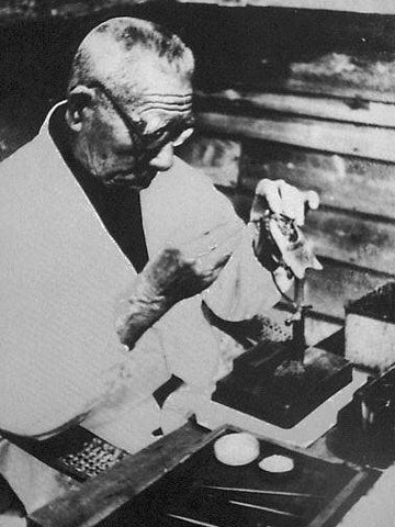 Kokichi Mikimoto inserting a nucleus in a pearl shell, 1945 -1954, photo public domain