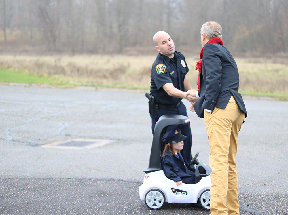 Step2 CEO Chris Quinn shakes hands with Streetsboro Police Officer after $10,000 SPD Donation