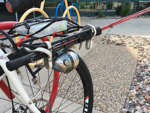 Items mounted to a rack on a bike with bow tie strap anchors