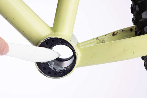 Bottom bracket cups are greased in a bike frame.