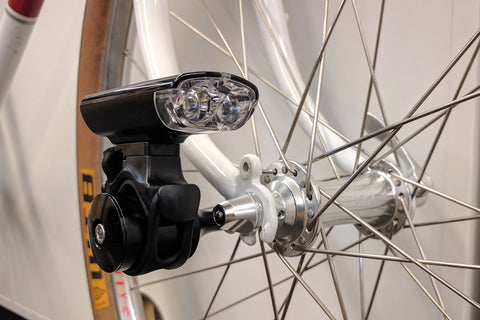 Braze-on light mount attached to the mid-blade mount of a fork.