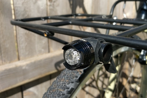 A bike headlight attached to the front rack