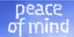 white clouds in a blue sky forming the words "peace of mind"