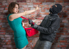 a woman pepper spraying a man trying to take her purse