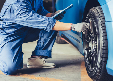 mechanic checking tires