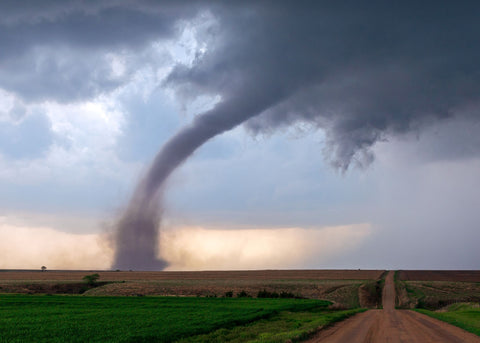 picture of a tornado approaching a road