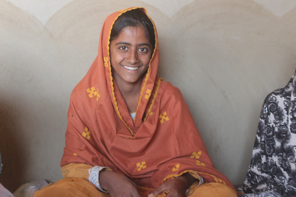 Aman (pictured), who is herself in early secondary school, helps her mother run female adult literacy classes in her village.