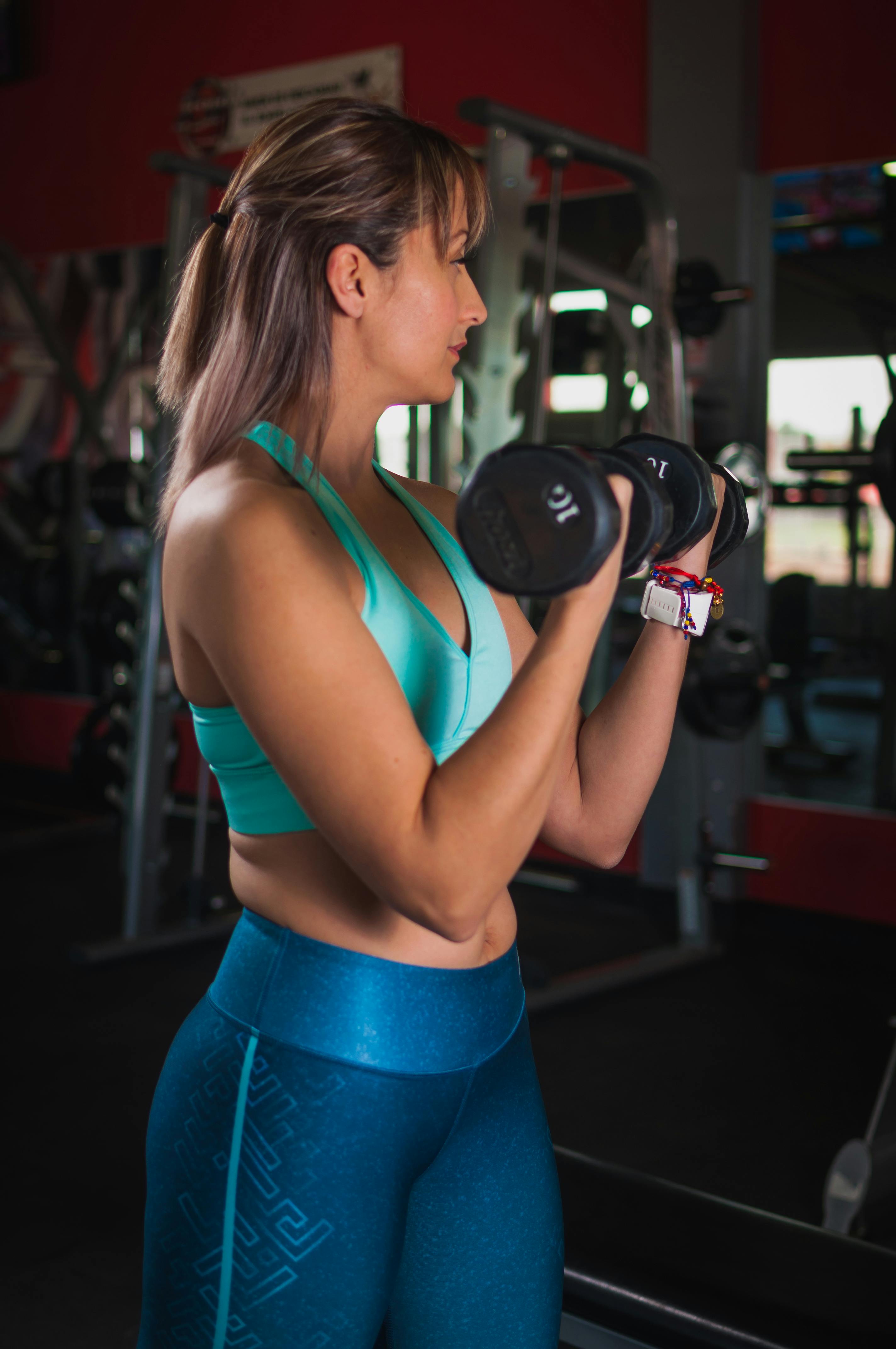 A person doing bodyweight exercises like push-ups or squats, or using dumbbells or resistance bands in a home or gym environment. 