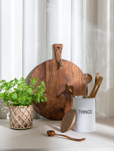wooden cutting board, white box and green plant in bamboo lantern
