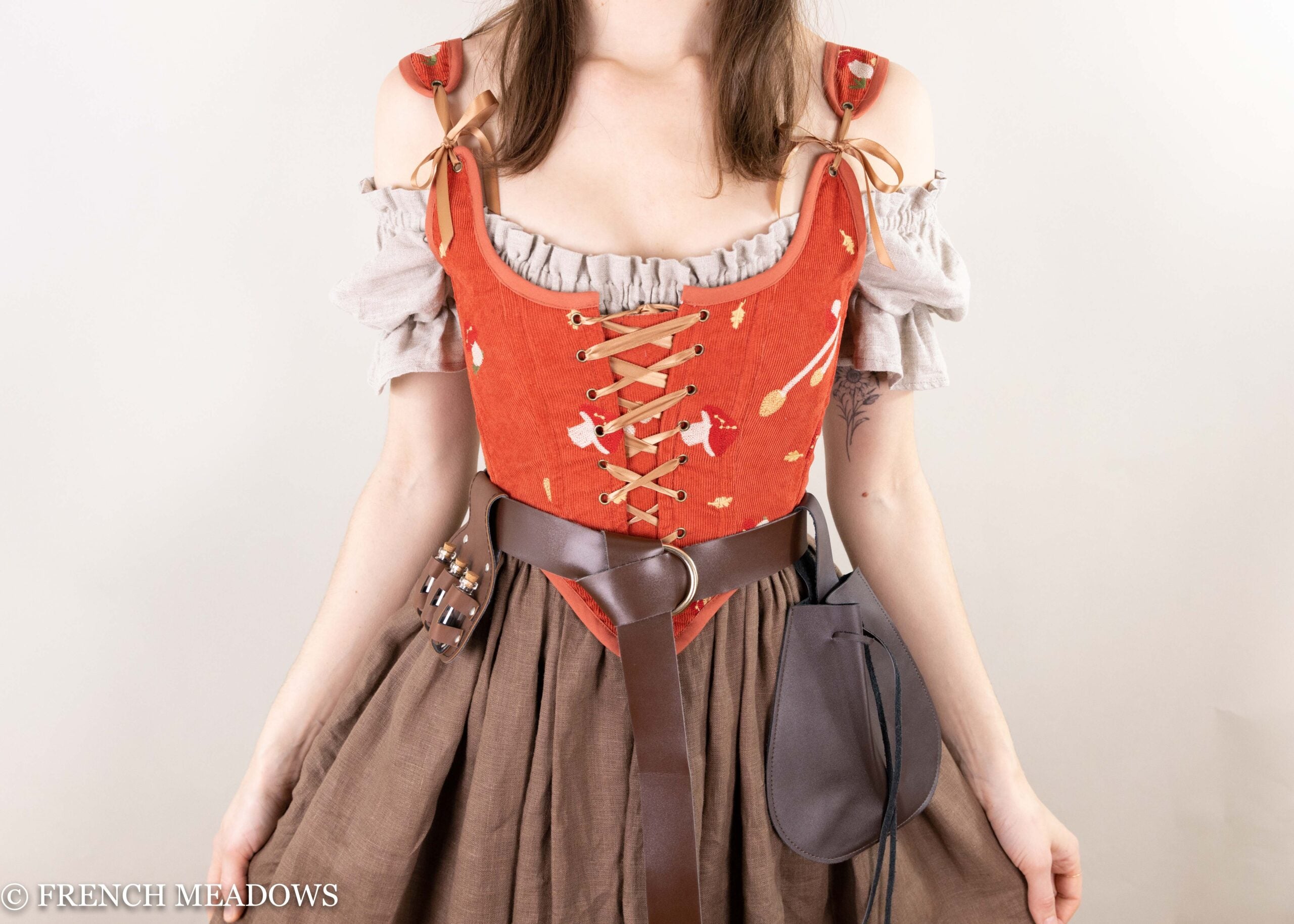 red renaissance fair bodice with embroidered mushroom design