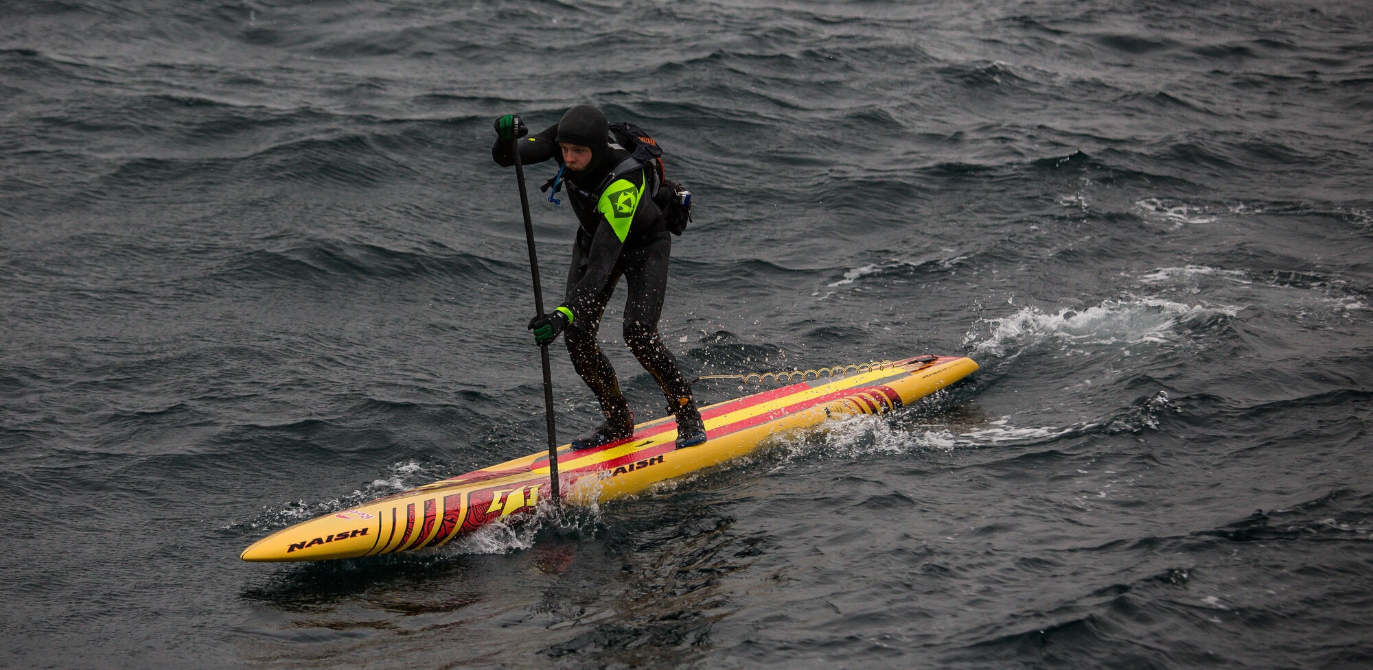 Side view of Casper Steinfath in the middle of his viking crossing from Denmark to Norway on a Naish SUP