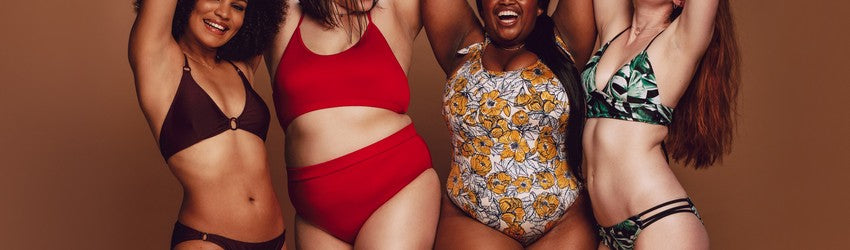 Body Positivity - four women stand in a row with different body types.