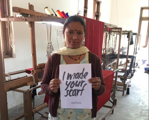 Artisan holding up a Fashion Revolution Sign