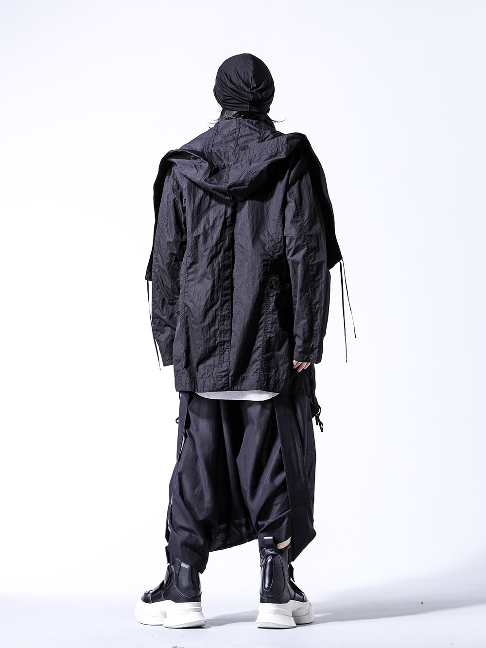 JULIUS 2024SS Styling - Spring style with plaster color accent - 859COM1-Black(Cotton/Nylon Gabadine Drape Coat) 857CUM4-Plaster(Cotton Rib Sleeveless Drape Cut & Sewn) 859ACU5-Black(Rayon Silk Jersey Beanie Cap) 857PAM13-Black(Cotton / Nylon / Twill Twisted Sarouel Pants) 857FWM2-Black-White(Cow Leather Velcro Shell Boots) - 1-004