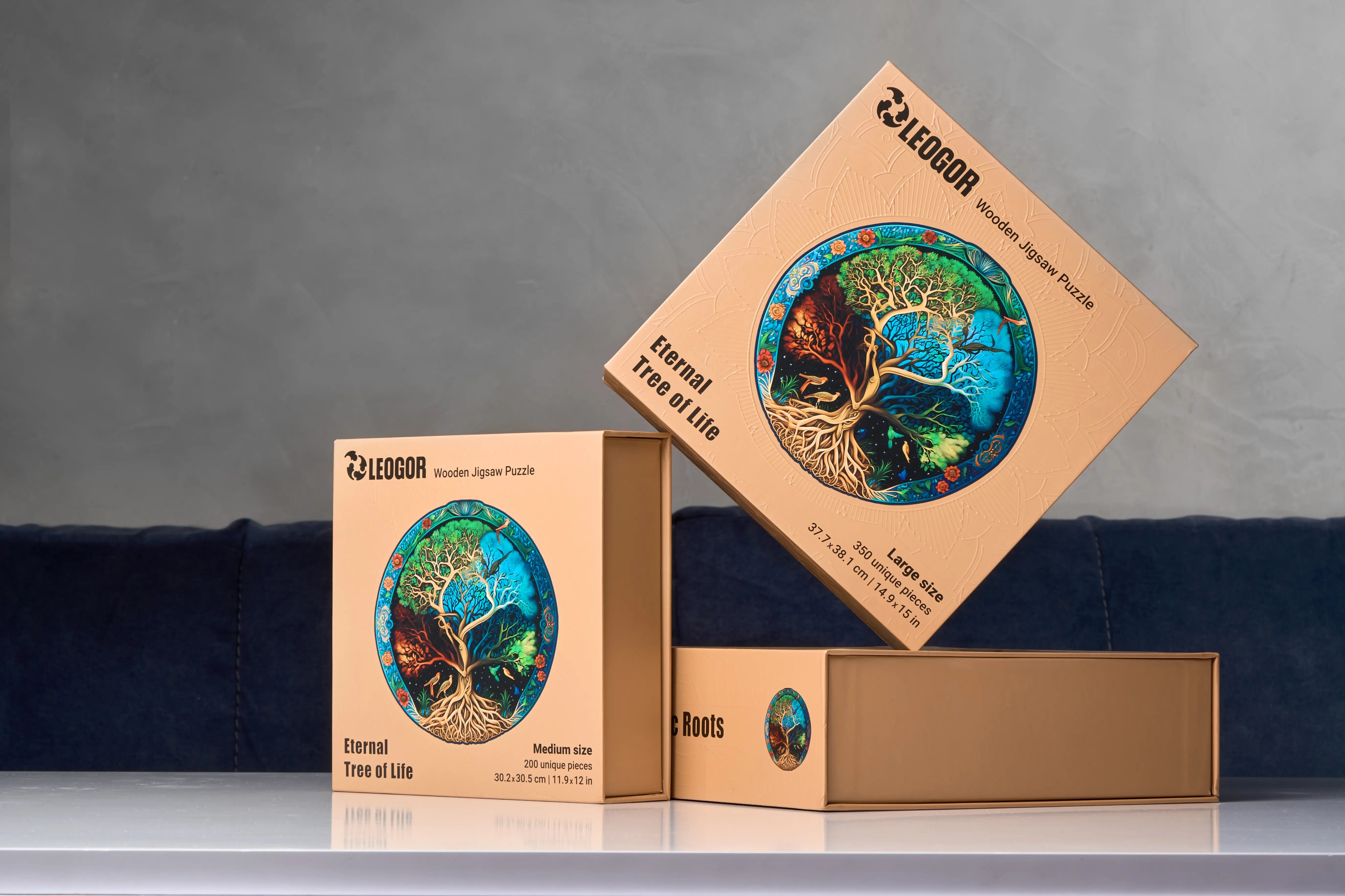 Three premium boxes of wooden christmas jigsaw puzzles for adults with Tree of Life designs on display