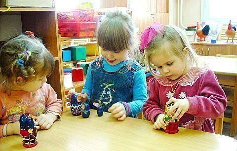 Children play with nesting dolls