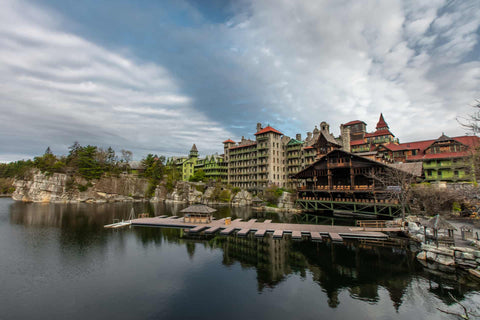 Exterior view of Mohonk Mountain House, with a wooden pier and by the lake