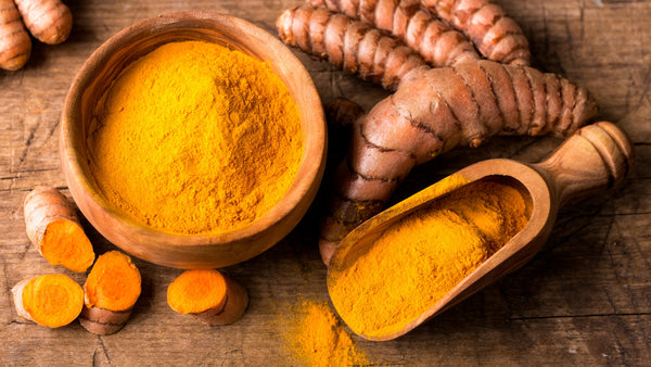 raw turmeric and powder turmeric on table