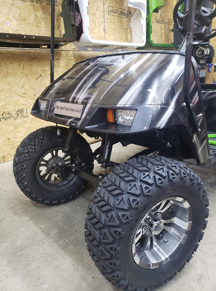 Gotham or Vampire wheel and off road tire combo in gunmetal finish installed on golf cart.