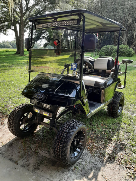 Stallion gloss black 14" wheels with 23x10-14 Sahara Classic tires installed on EZGO TXT golf cart.