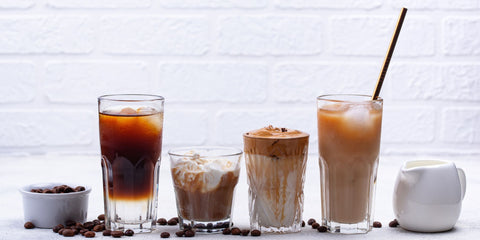 A lineup of coffee drinks, such as an espresso, a latte, a cortado, and more.