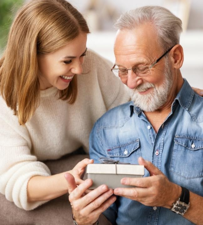 Une femme offrant un cadeau à son père