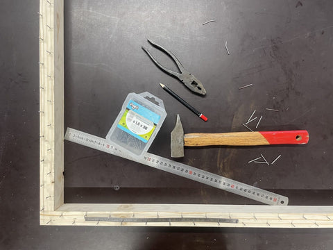 work table with a tufting frame under construction