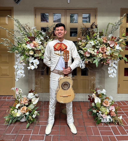 Flower backdrop pedestals caramel tan and coffee Mariachi at Cigar Bar for event