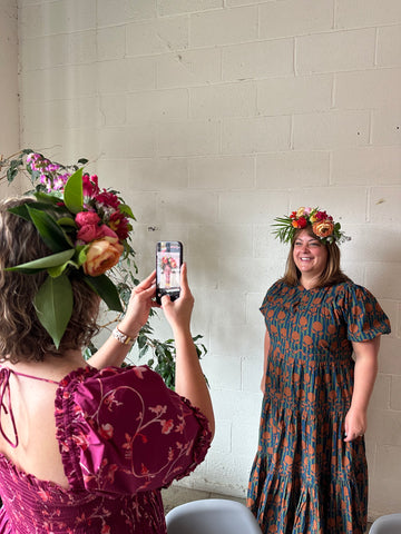 A Gorgeous and Green Flower Party Attendee getting a photo with their Head Garland