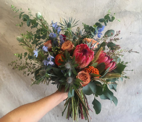 The Rustic protea and summer blooms bridal bouquet for a Yosemite wedding.