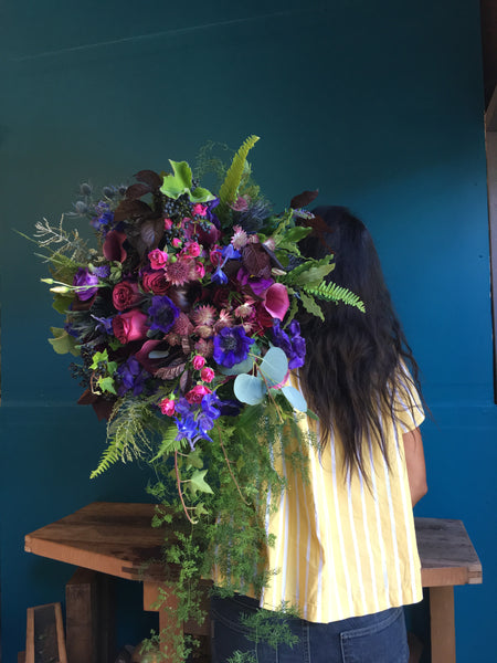 Oversized bridal bouquet in purples, blue and violets  over my shoulder by Gorgeous and Green
