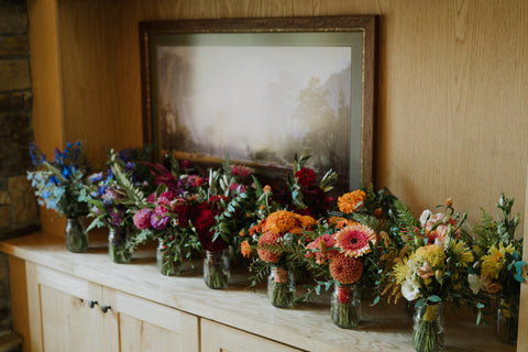 Rows of bridesmaid bouquets for wedding at Evergreen Lodge Yosemite Wedding flowers by Gorgeous and Green