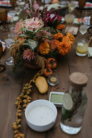 A shot of the table decor by Gorgeous and Green with fruits and textures for the second dinner at Holly Farm for a multi day wedding 