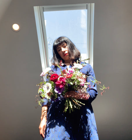 Pilar and a local hand tied bouquet made at home during COVID-19 