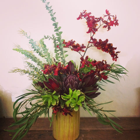 Long Lasting office arrangement with wild orchids and artichokes by Gorgeous and Green