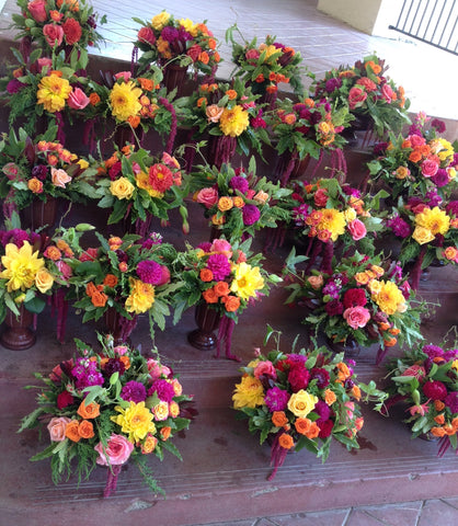 Rows of centerpieces by Gorgeous and Green waiting to be used at the St Vincent's School for Boys