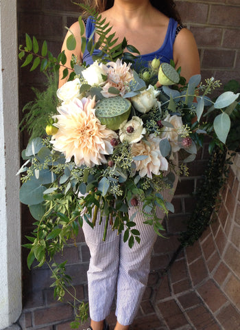 Oversized foliage, lotus and soft blush cafe au lait dahlia bridal bouquet by Gorgeous and Green