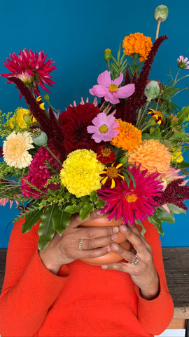 Pilar Zuniga's hands and local flowers in a vase for delivery to Oakland Berkeley Emeryville Orinda