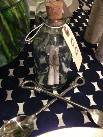 Tiny message in a bottle and crossed knot silverware for nautical table design by Gorgeous and Green