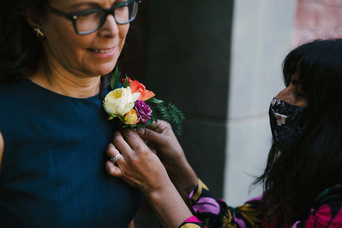 Pilar Zuniga pinning a corsage Fall Wedding Oakland