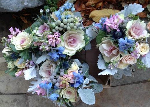 Centerpieces and bridesmaid bouquets in pinks and blues and silver by Gorgeous and Green