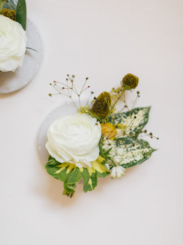 White ranunculus with textures for a summer wedding boutonniere by Gorgeous and Green